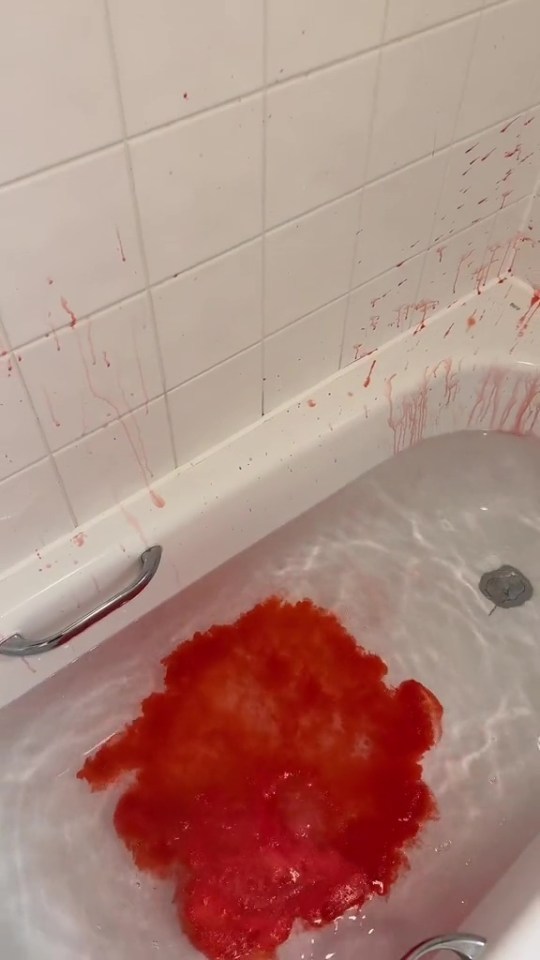 a bathtub filled with water and red liquid