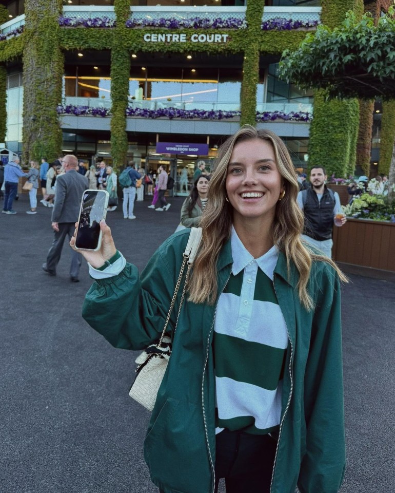 a woman stands in front of a building that says centre court