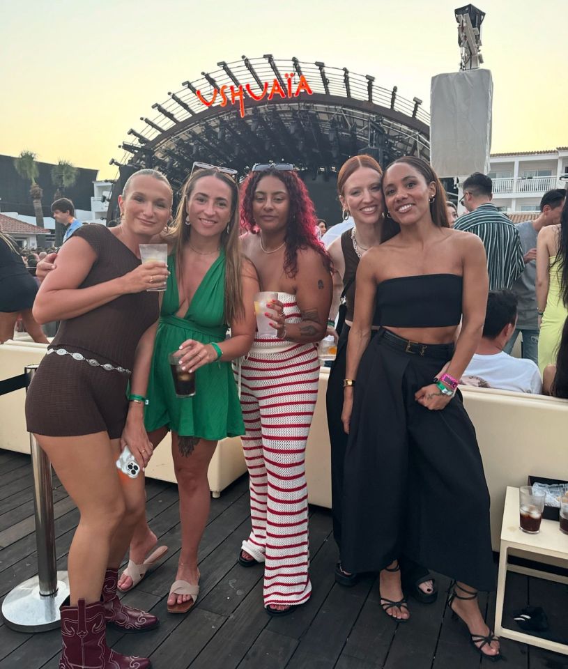 a group of women are posing for a picture in front of a sign that says huaja