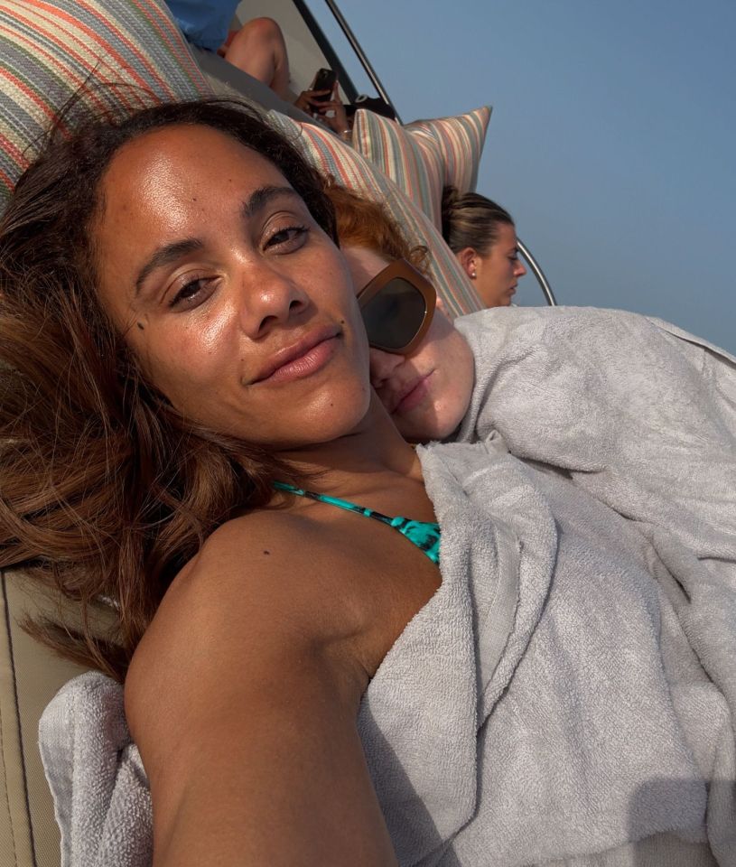 a woman in a bikini is sitting on a boat