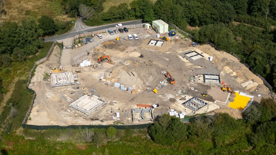 an aerial view of a construction site surrounded by trees