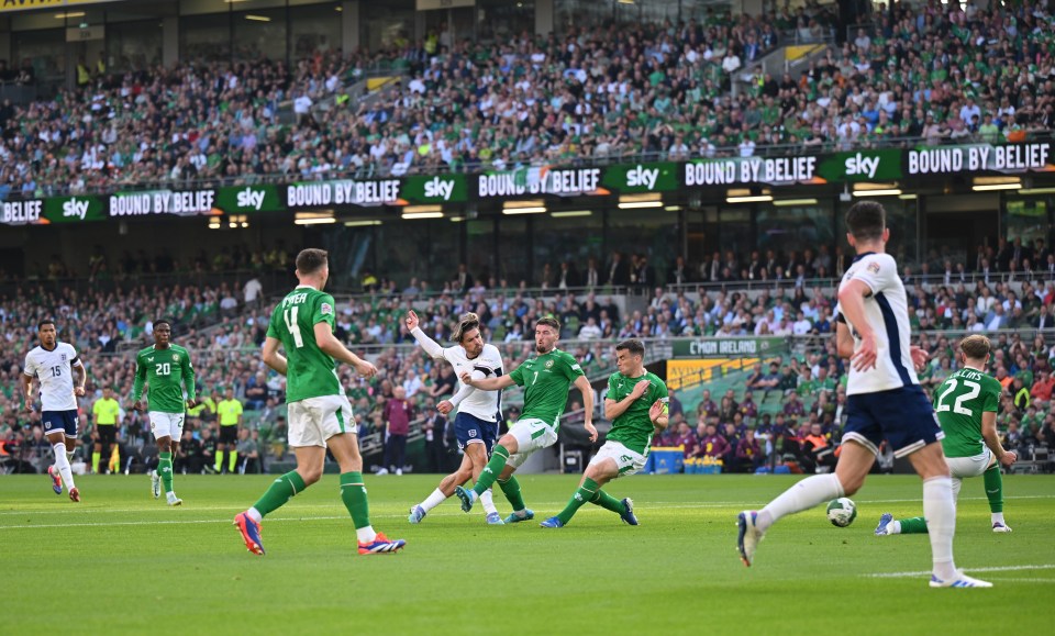 a soccer game is being played in front of a sign that says bound by belief