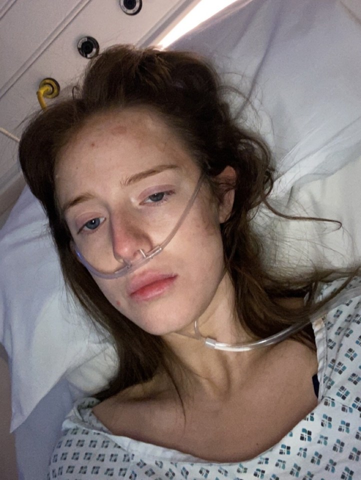 a woman in a hospital bed with an oxygen tube in her nose