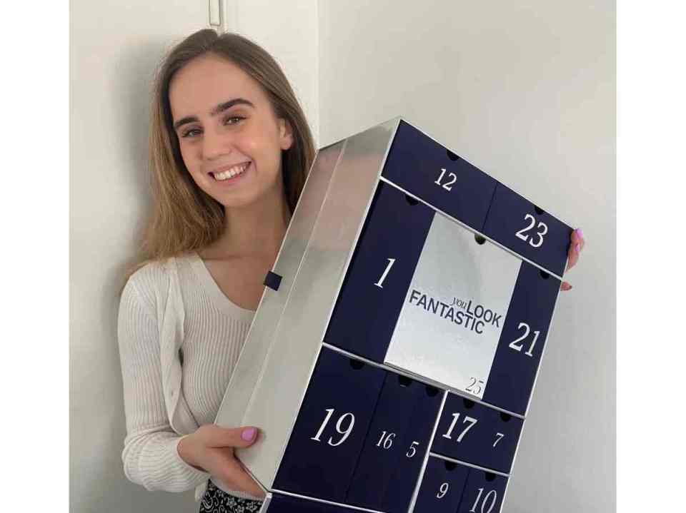 a woman is holding a box that says ' i look fantastic ' on it