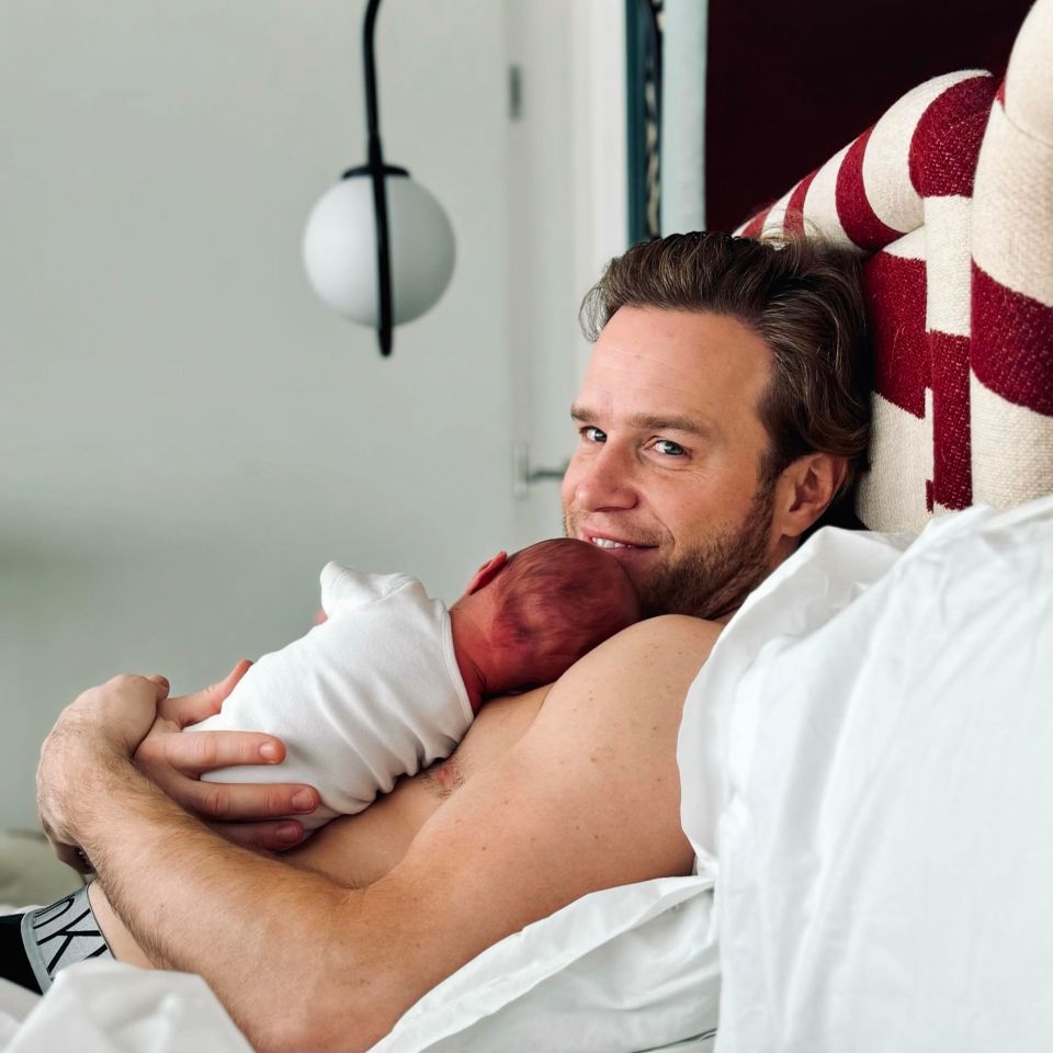 a man is holding a newborn baby in his arms