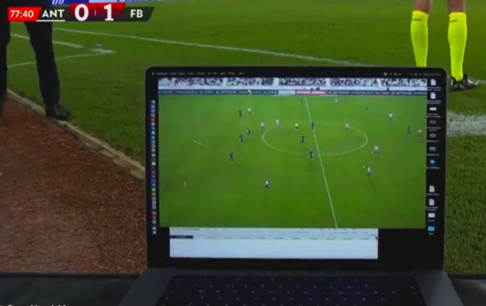 a laptop screen shows a soccer game between ant and fb