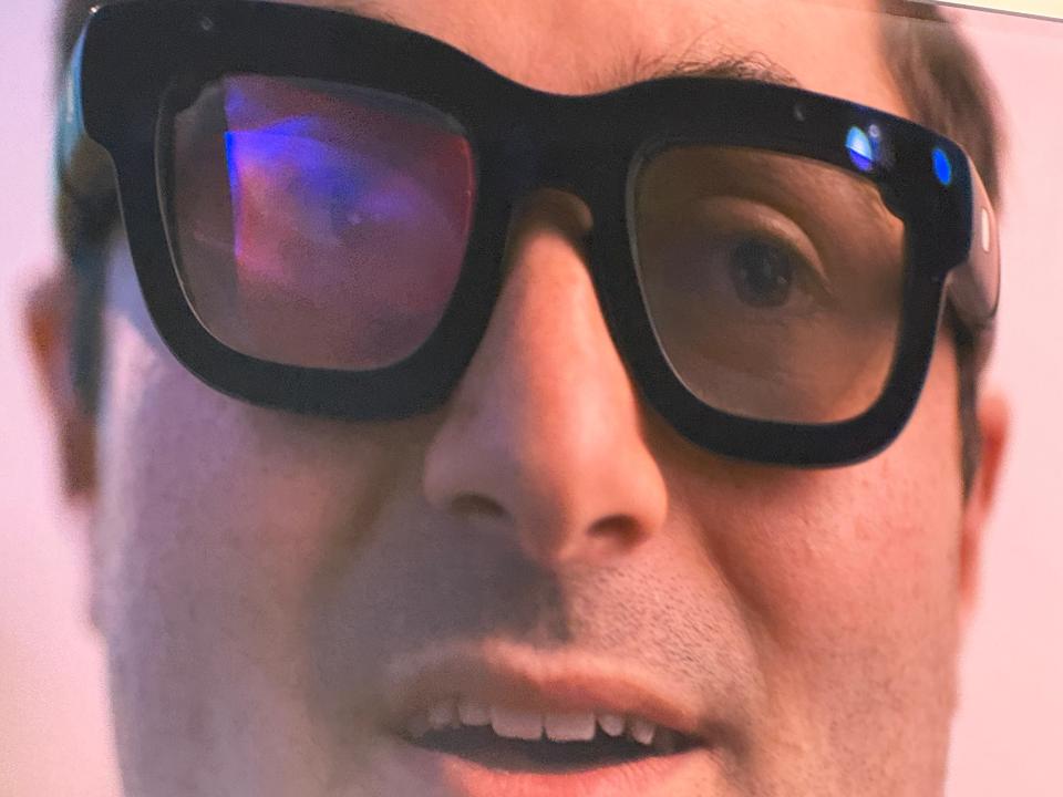 a close up of a man 's face wearing sunglasses