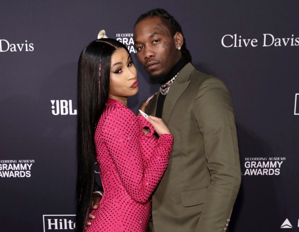 a man and a woman pose for a picture at the grammy awards
