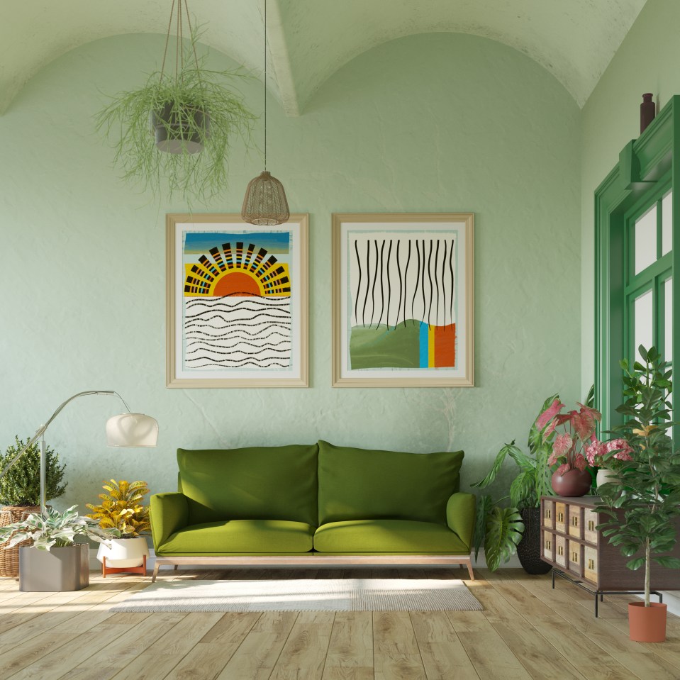 a living room with green walls and a green couch