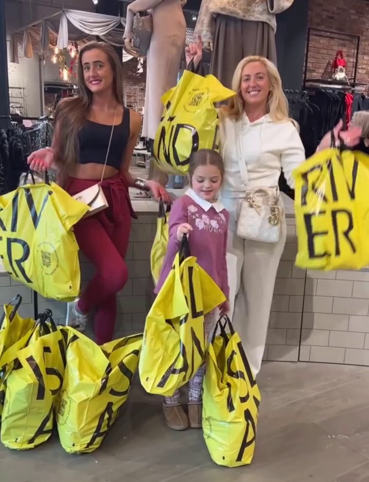 a little girl is holding a yellow bag that says river
