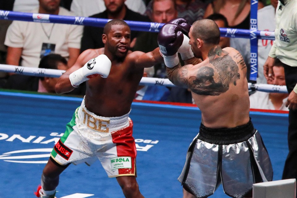 two boxers are fighting in a ring with the word bbva on the ropes