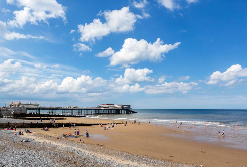 a beach with a sign that says ' ice cream ' on it