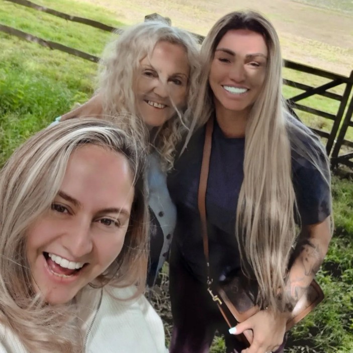 three women are posing for a picture in a field