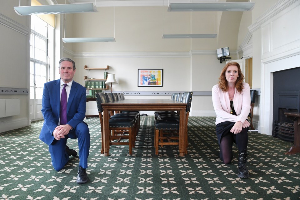 a man and a woman kneeling in front of a table
