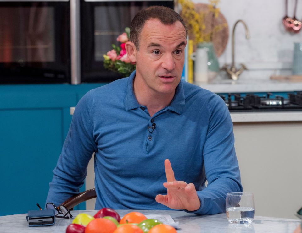 a man in a blue shirt is sitting at a table with fruit