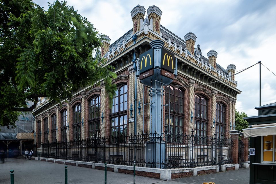 a brick building with a mcdonald 's sign in front of it