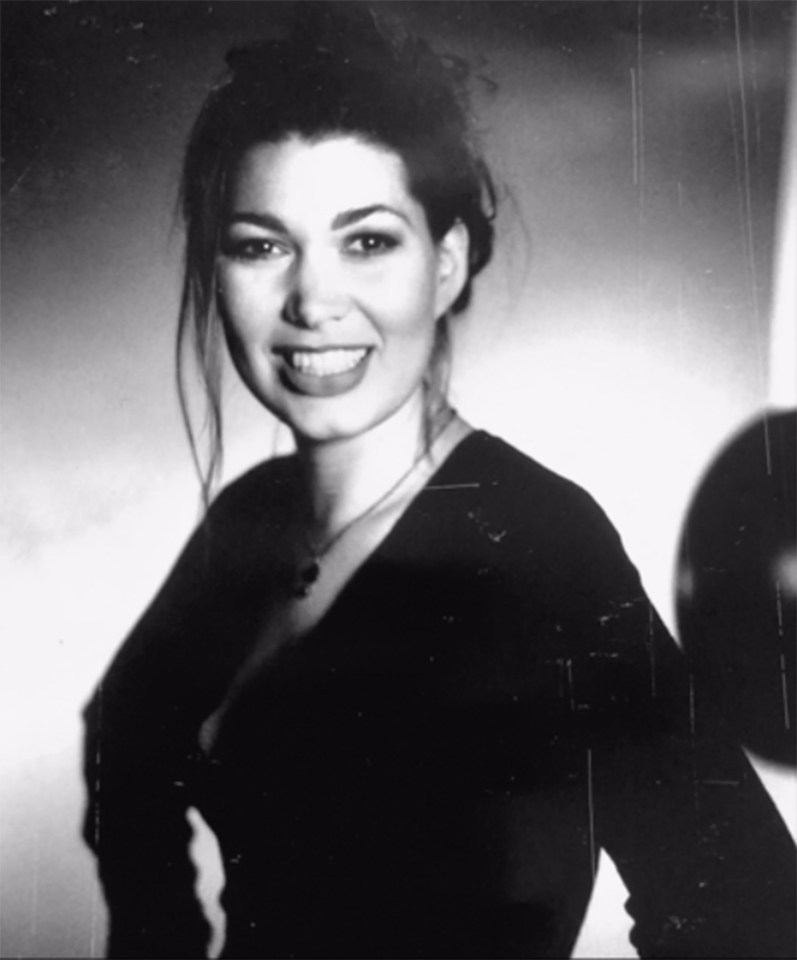 a black and white photo of a smiling woman