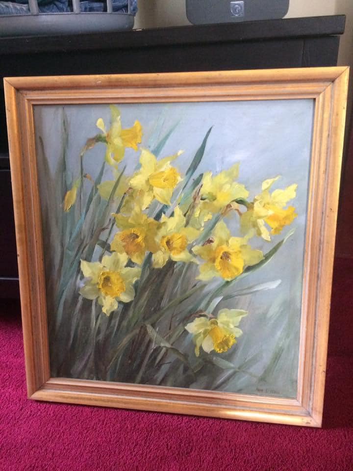 a painting of yellow flowers in a gold frame