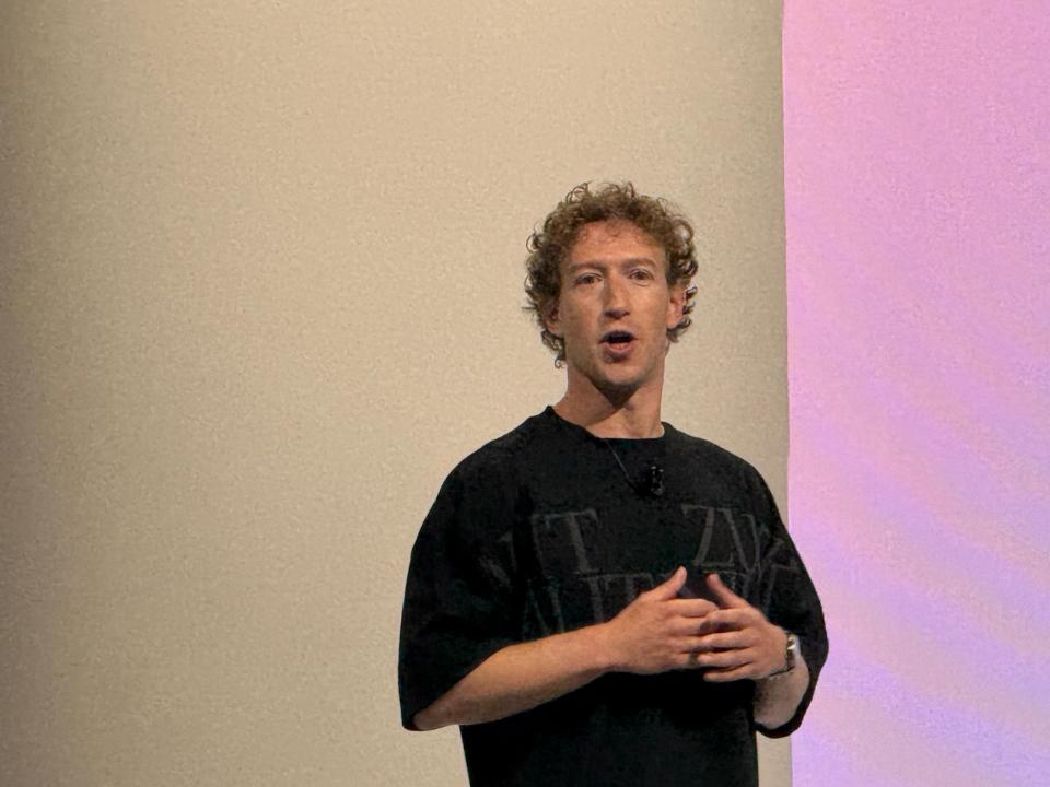 a man wearing a black shirt that says ' tzk ' on it