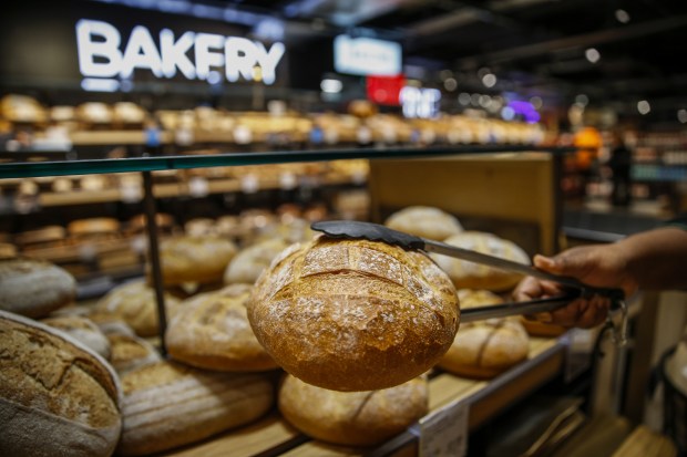 a loaf of bread is being displayed in front of a sign that says bakery