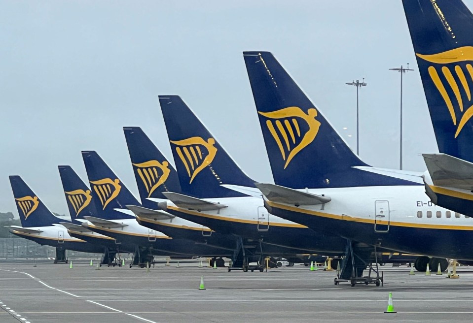 a row of ryanair planes are parked on the tarmac