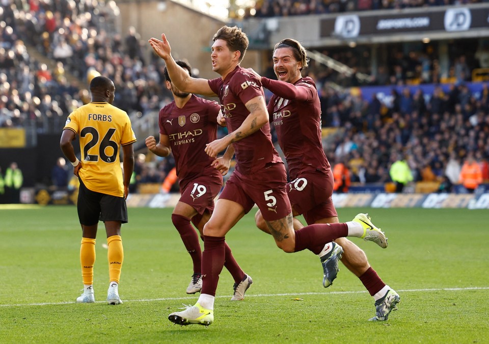 a soccer player wearing a number 26 jersey celebrates with his teammates