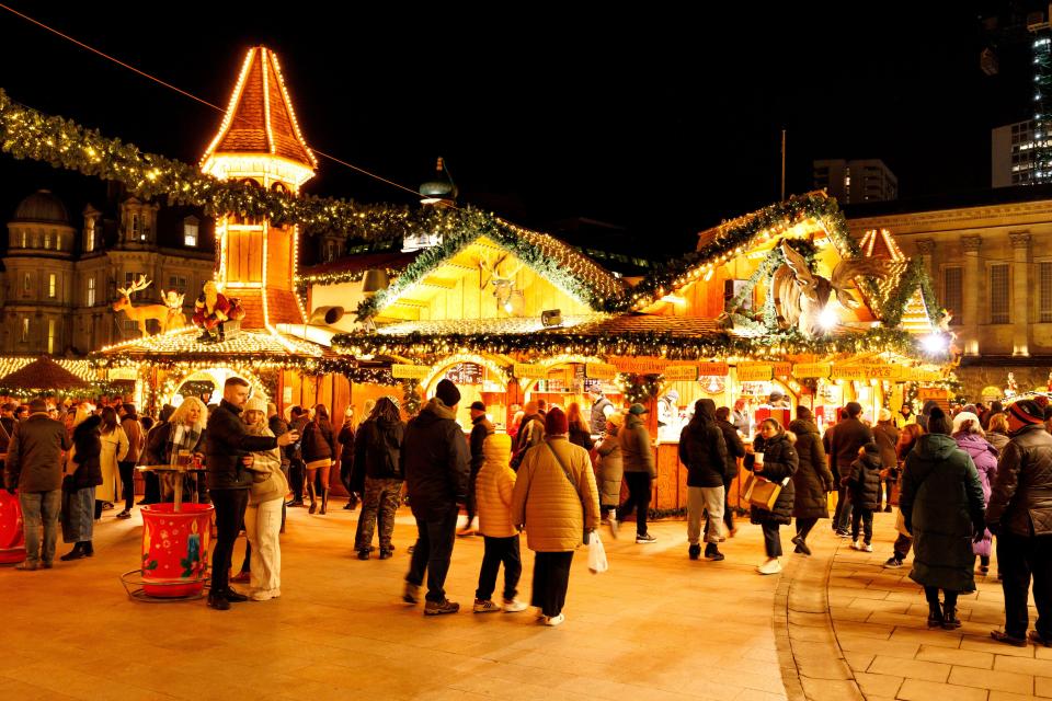 a crowd of people are gathered at a christmas market