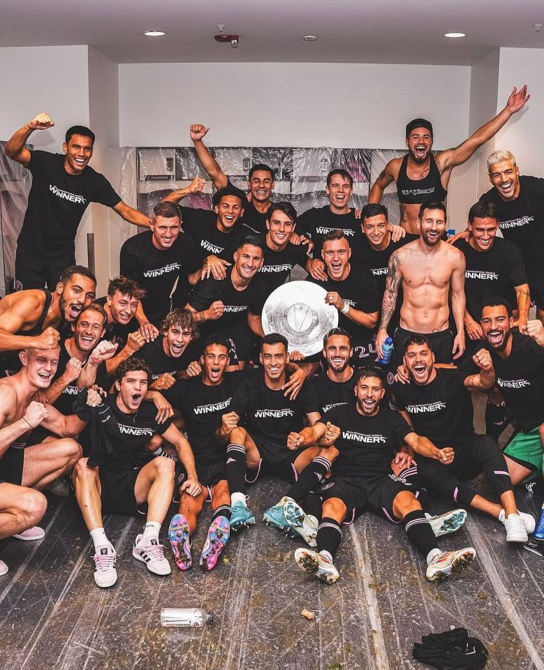 a group of soccer players wearing black shirts that say winners