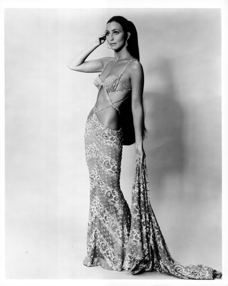 a black and white photo of cher in a dress