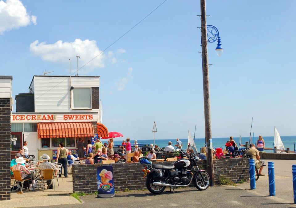 a motorcycle is parked in front of an ice cream shop