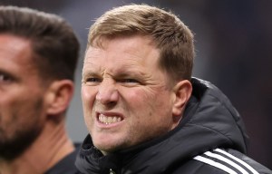 a man wearing an adidas jacket stands next to another man