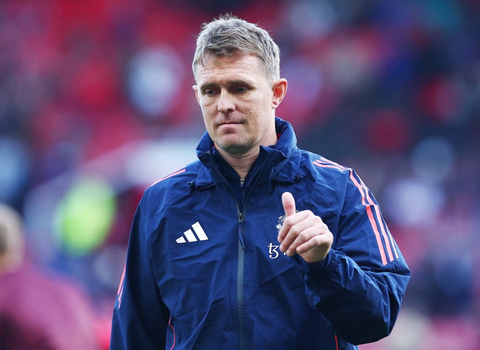 a man wearing an adidas jacket giving a thumbs up
