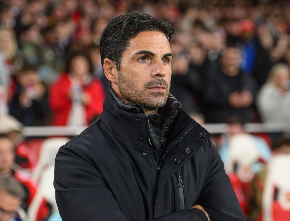 a man wearing a black jacket with the word arsenal on it