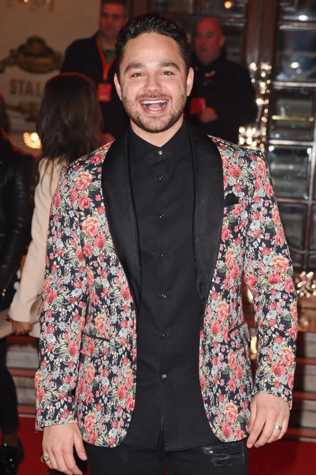 a man wearing a floral jacket and a black shirt