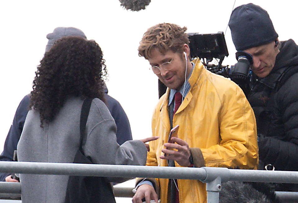 a man in a yellow jacket is talking to a woman