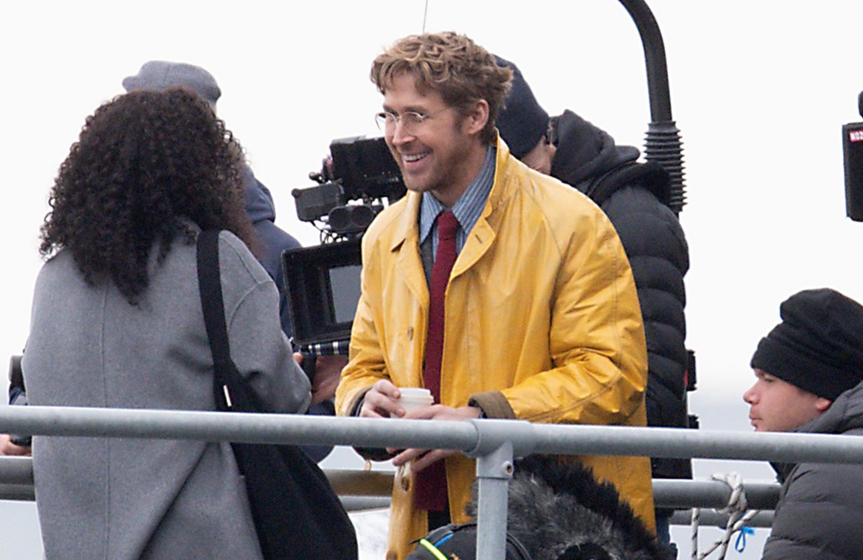 a man in a yellow jacket is talking to a woman