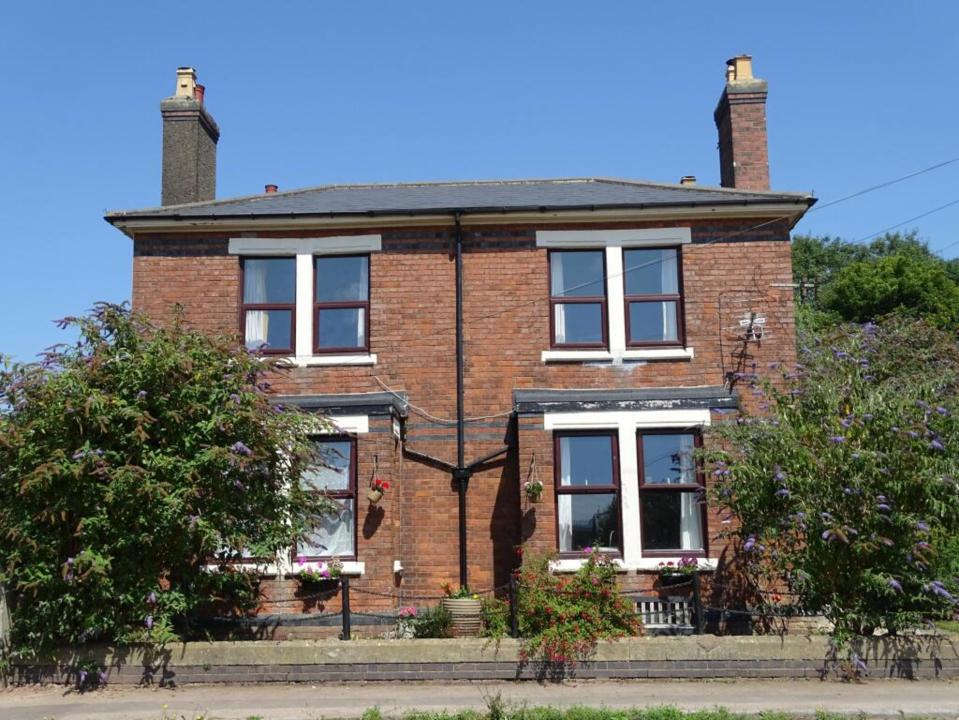 a brick house with a chimney on top of it