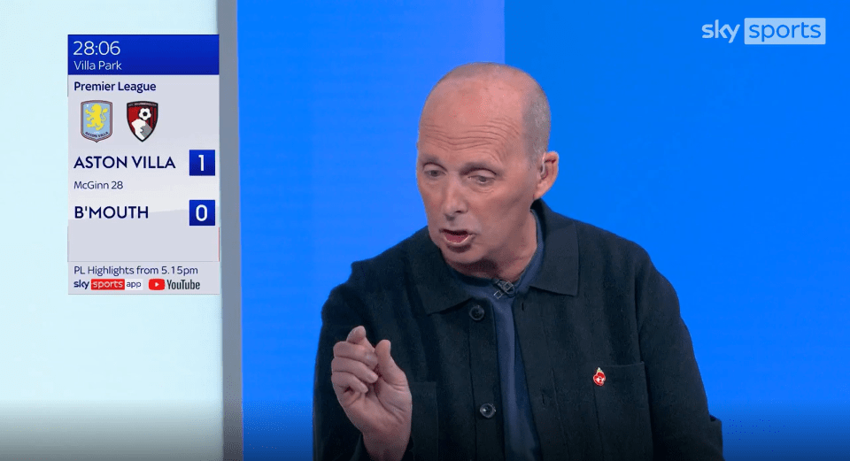 a man in front of a screen that says sky sports