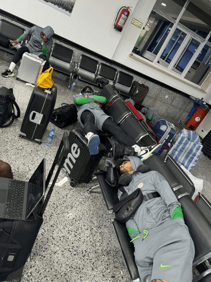 a person laying on a bench with a suitcase that says me on it