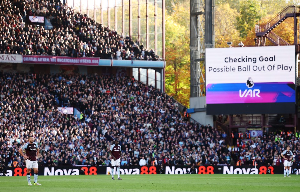 a soccer field with a large screen that says checking goal possible ball out of play