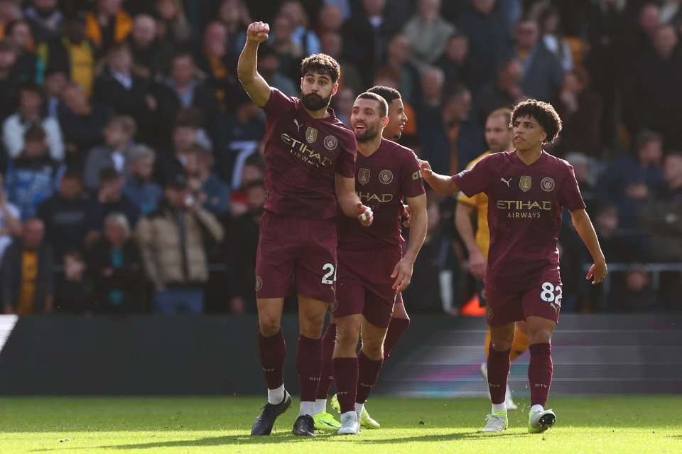 a group of soccer players wearing shirts that say etihad airways