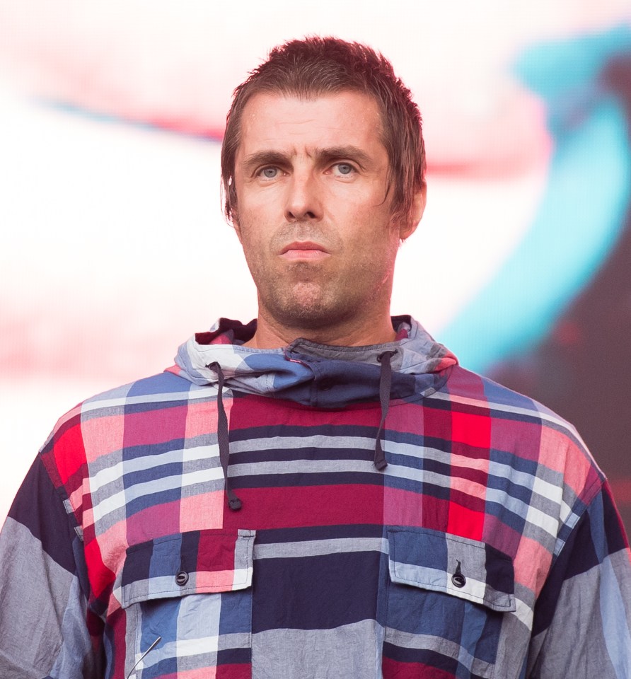 a man in a plaid shirt is looking at the camera