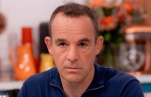 a man sitting at a table with his hands folded