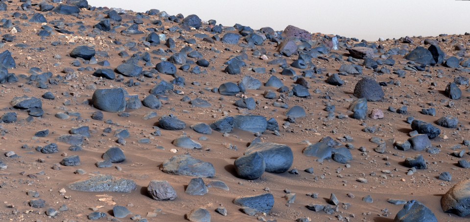 a landscape of rocks and dirt with a white sky in the background