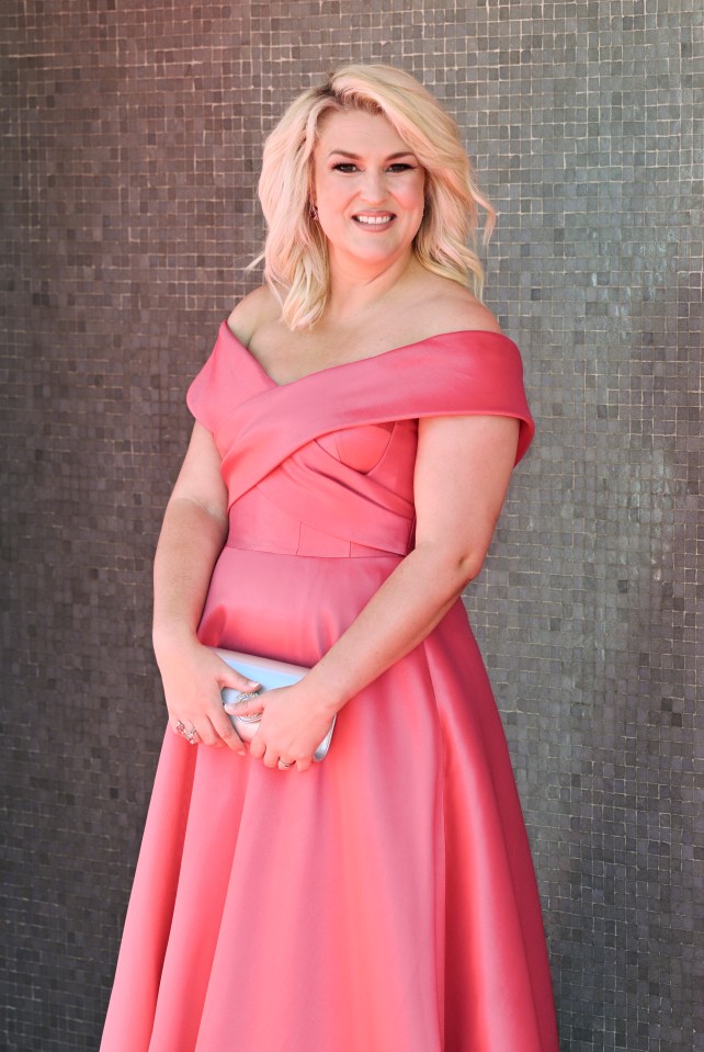 a woman in a pink off the shoulder dress holds a white clutch