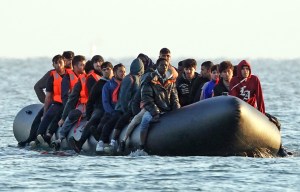 a group of people in a boat with one wearing a hoodie that says ' abercrombie &amp; fitch ' on it