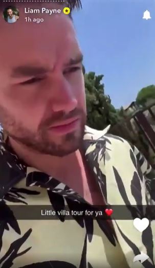 a man with a beard is wearing a hawaiian shirt .