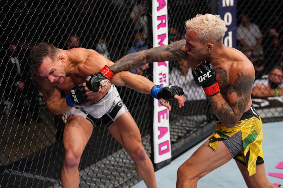 two fighters in a cage with a sign that says arm head