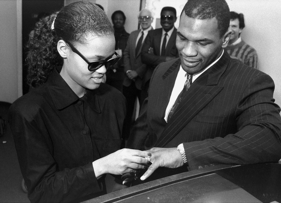 a man in a suit is putting a ring on a woman 's finger