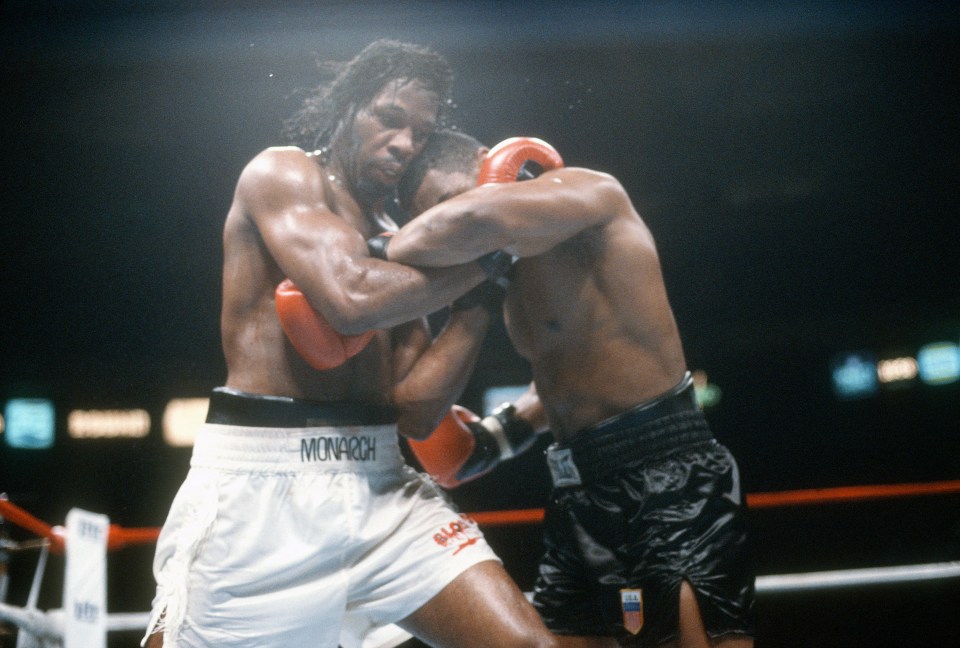 a boxer wearing monarch shorts is fighting another boxer